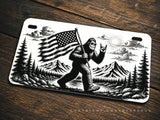Bigfoot Mountains Forest USA American Flag Humor Motorcycle License Plate